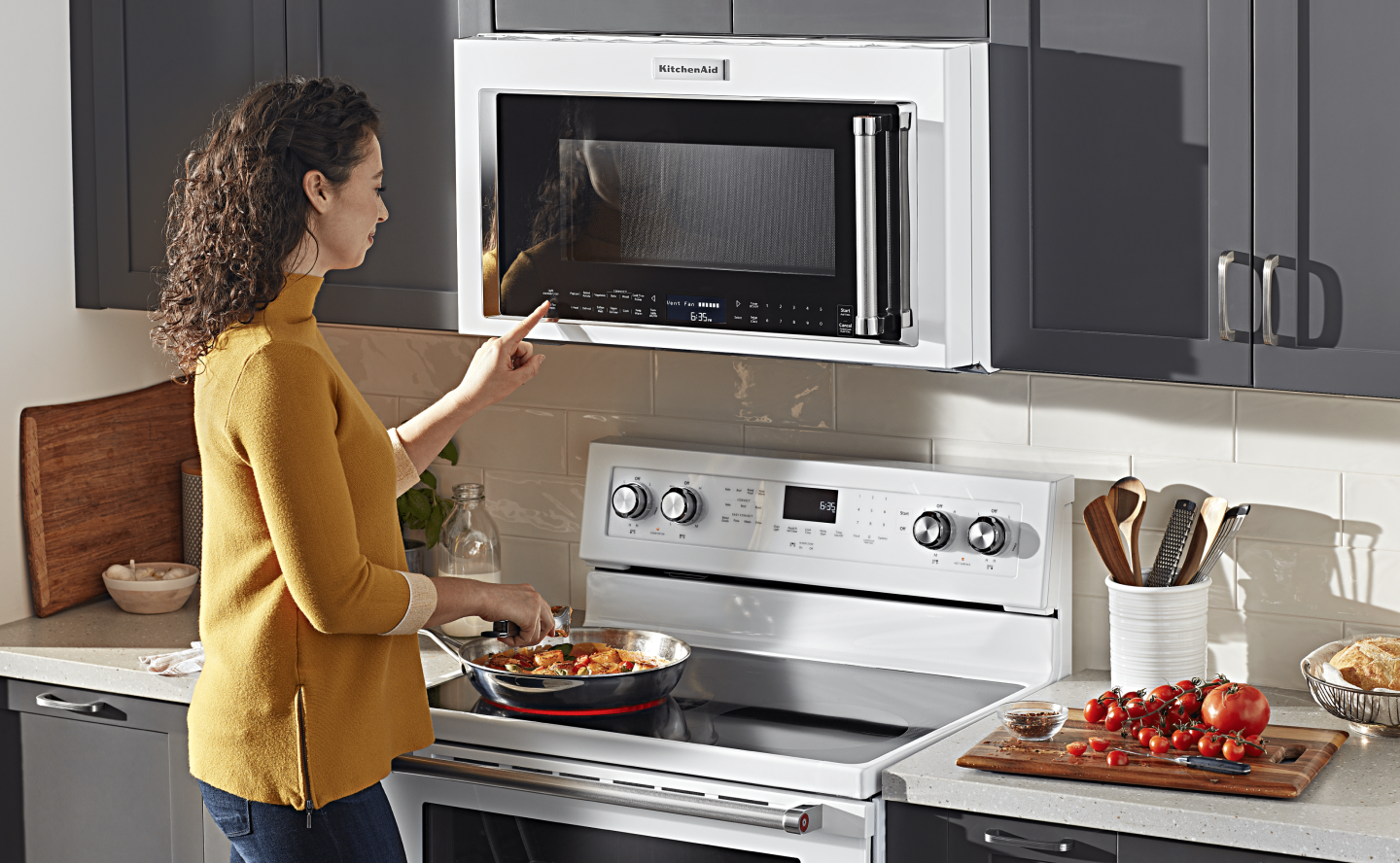 Person selecting a setting on a microwave Person selecting a setting on a microwave