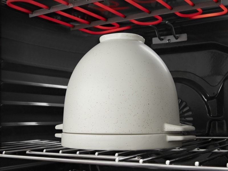Bread proofing bowl with the lid on in the oven