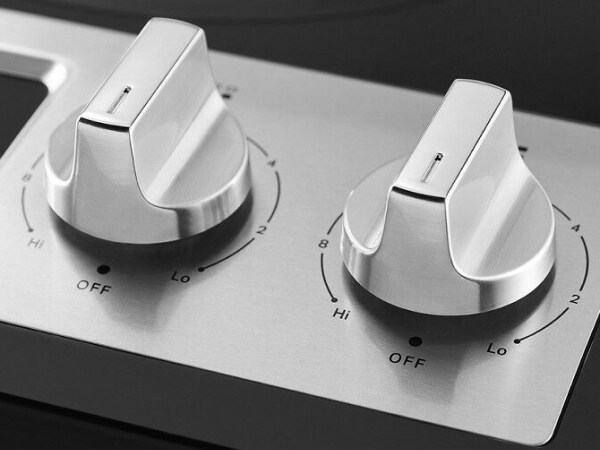 Close-up of silver burner knobs for electric stovetop