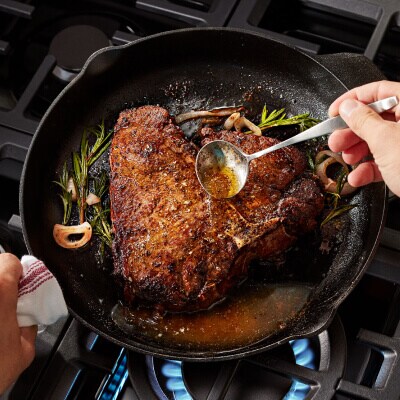 Person basting steak