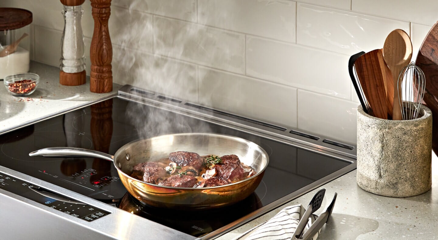 Steak cooking on a cooktop Steak cooking on a cooktop