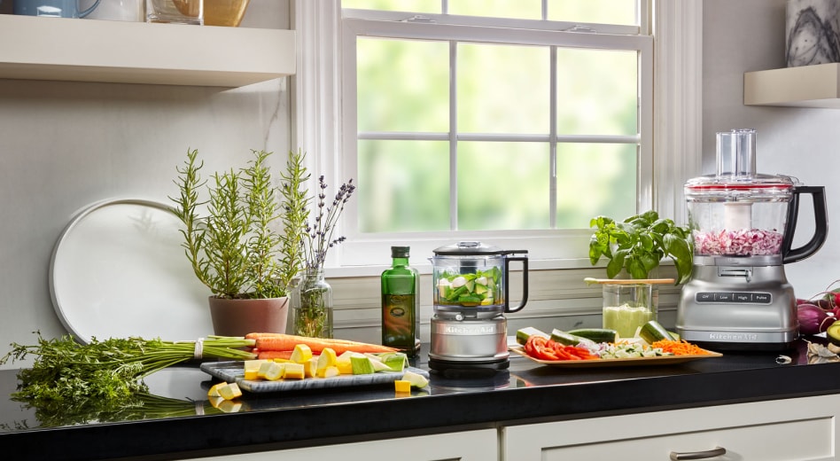 Vegetables being prepped on a counter next to KitchenAid® countertop appliances Vegetables being prepped on a counter next to KitchenAid® countertop appliances
