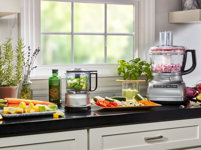 Vegetables being prepped on a counter next to KitchenAid® countertop appliances Vegetables being prepped on a counter next to KitchenAid® countertop appliances