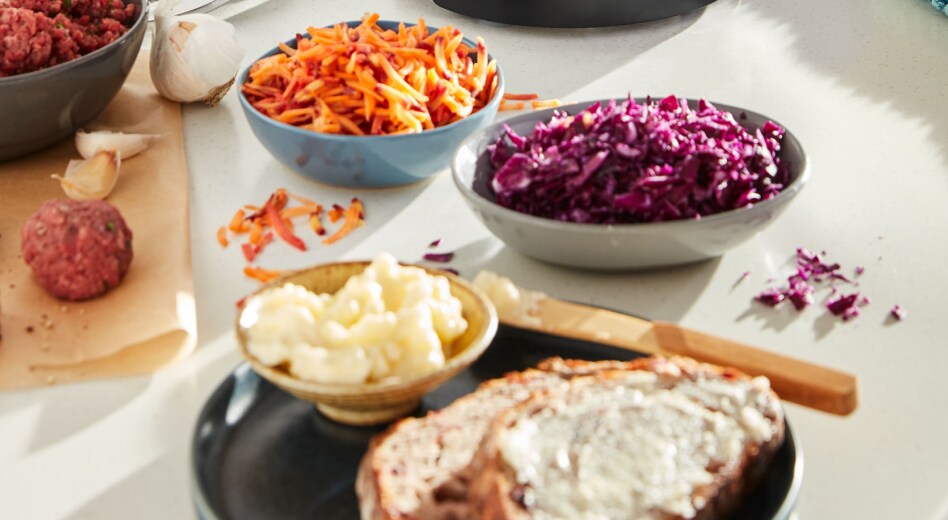 Shredded carrots and cabbage next to buttered toast Shredded carrots and cabbage next to buttered toast