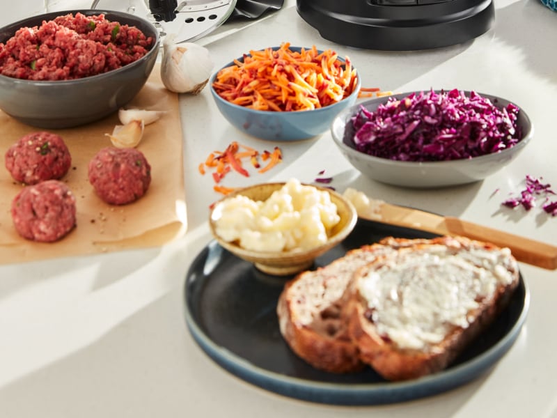 Shredded carrots and cabbage next to buttered toast Shredded carrots and cabbage next to buttered toast