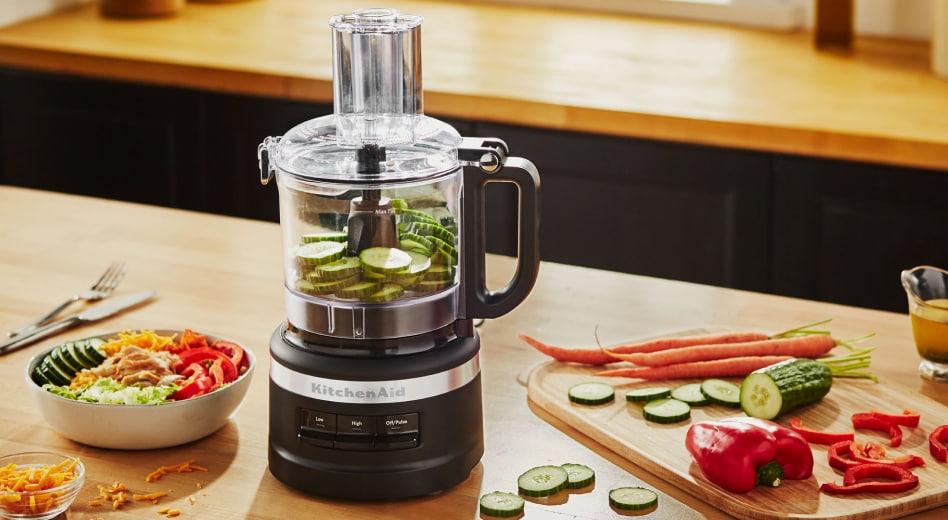 Sliced cucumbers inside a black KitchenAid® food processor Sliced cucumbers inside a black KitchenAid® food processor