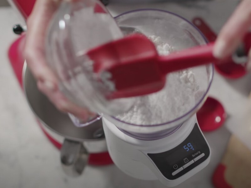 Flour being scooped into a bowl on the scale attachment