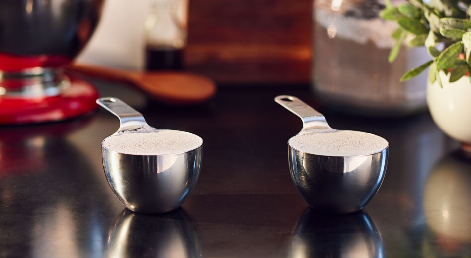 Two measuring cups filled with flour Two measuring cups filled with flour