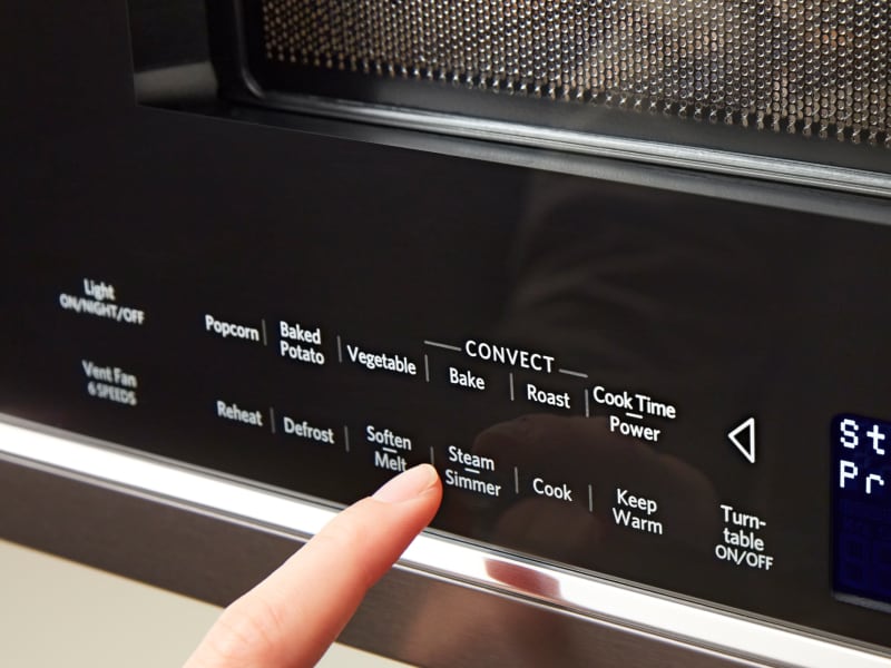 Person selecting Steam/Simmer on a KitchenAid® microwave