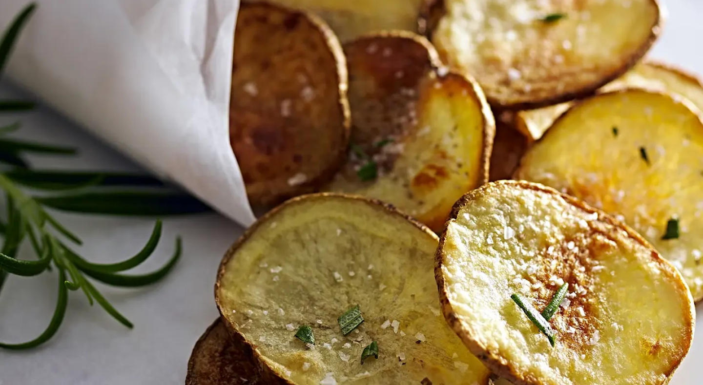 Homemade potato chips garnished with chives Homemade potato chips garnished with chives