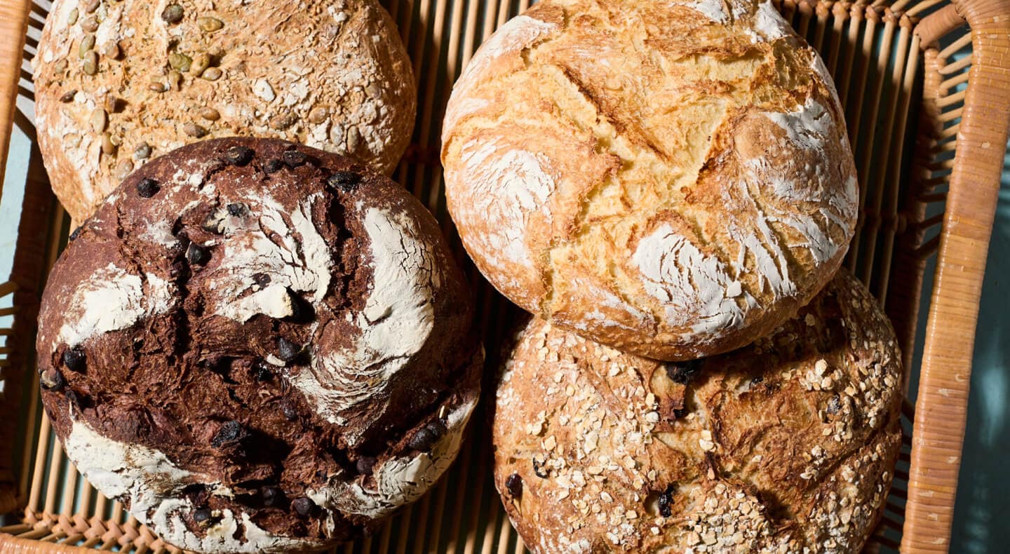 Four loaves of bread in a basket Four loaves of bread in a basket