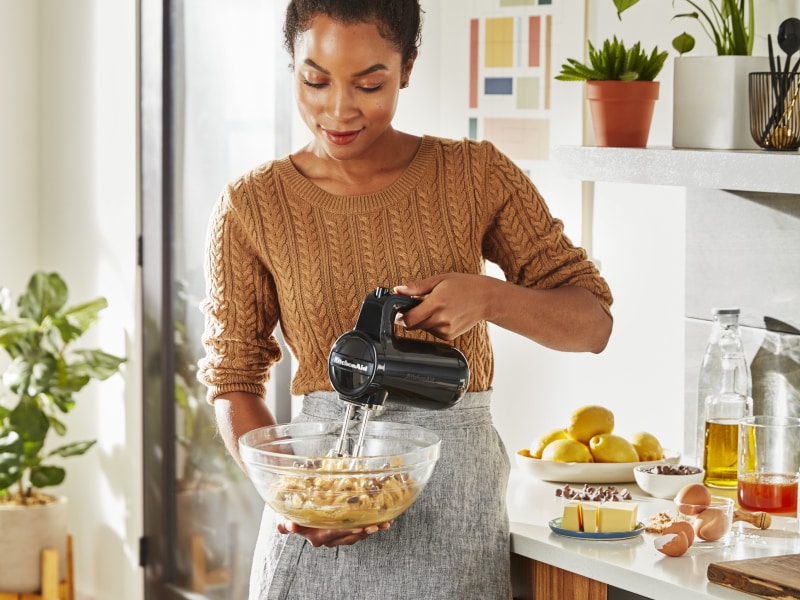 Person using KitchenAid® cordless hand mixer Person using KitchenAid® cordless hand mixer