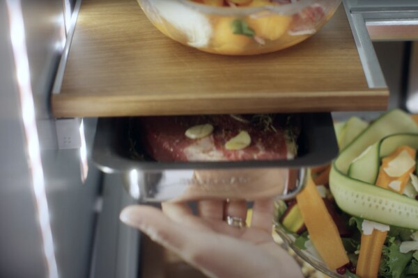 Meat in a marinating drawer in a KitchenAid brand refrigerator