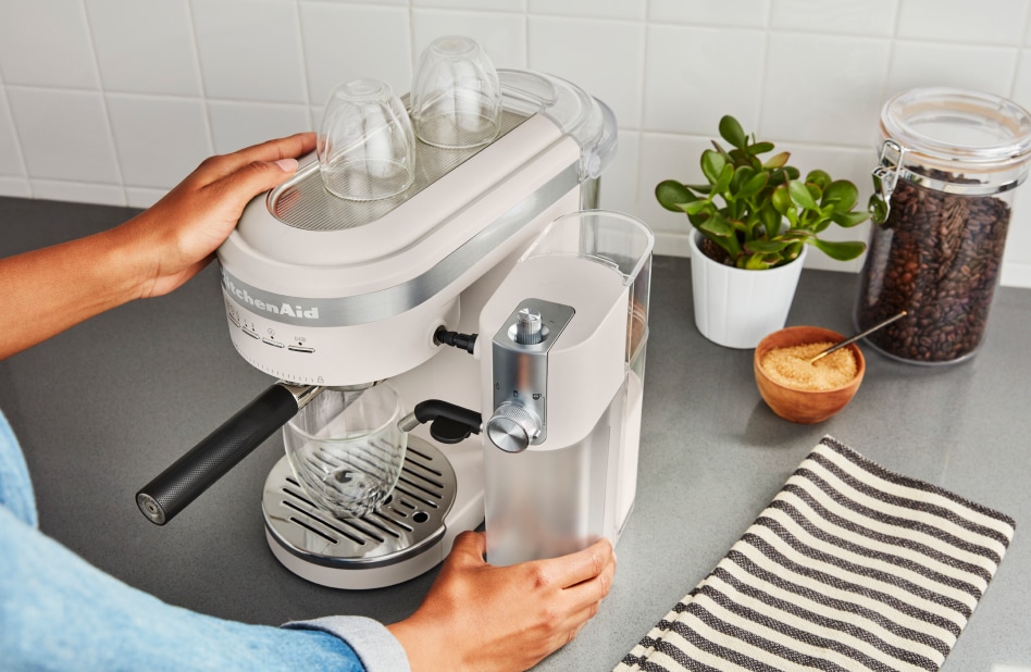 Person attaching automatic milk frother to KitchenAid® espresso machine Person attaching automatic milk frother to KitchenAid® espresso machine