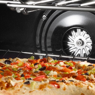 Interior of oven with baking pizza