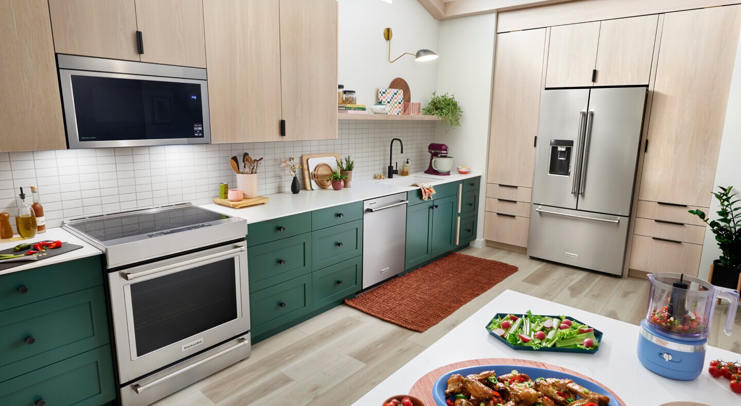 KitchenAid® stainless steel suite of appliances in light brown cabinetry