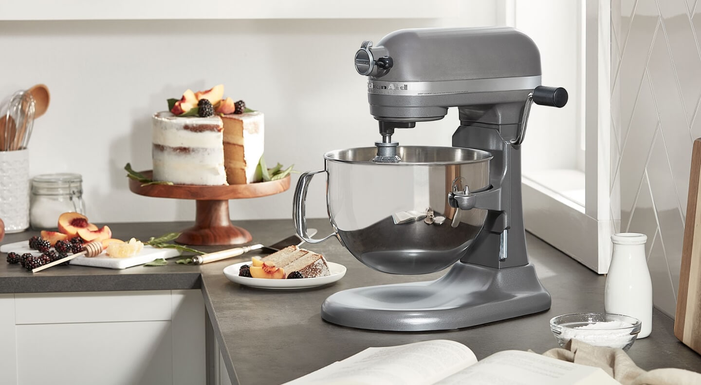KitchenAid® bowl lift stand mixer next to layer cake on cake stand KitchenAid® bowl lift stand mixer next to layer cake on cake stand