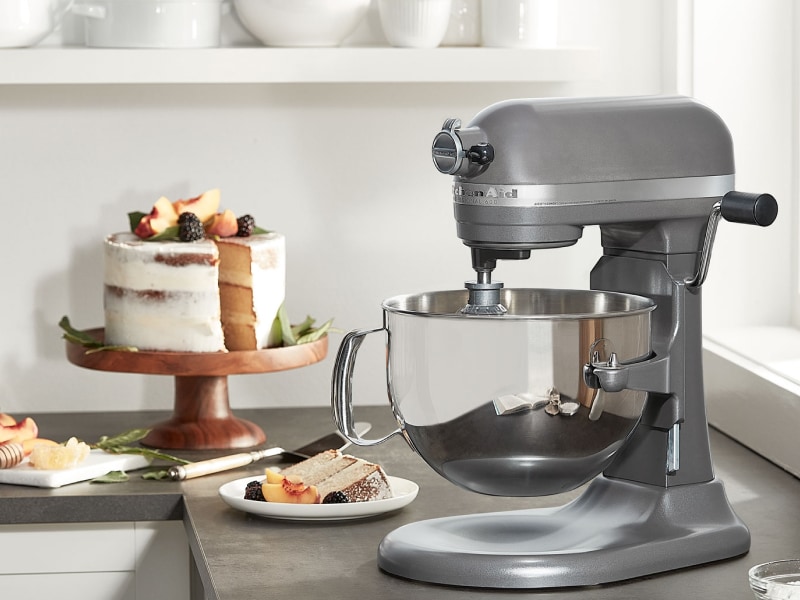 KitchenAid® bowl lift stand mixer next to layer cake on cake stand KitchenAid® bowl lift stand mixer next to layer cake on cake stand