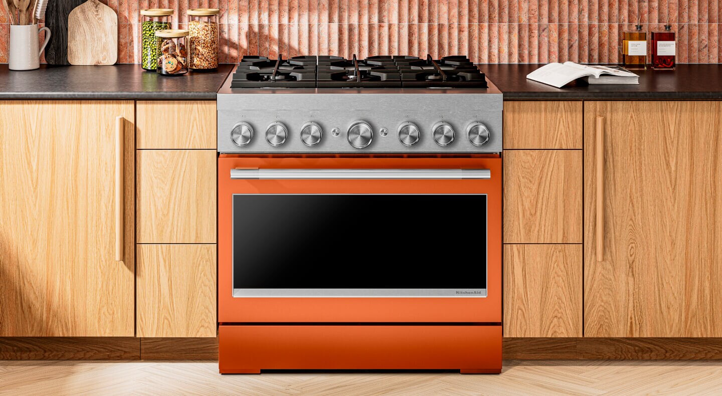 KitchenAid® commercial range set in light brown cabinetry