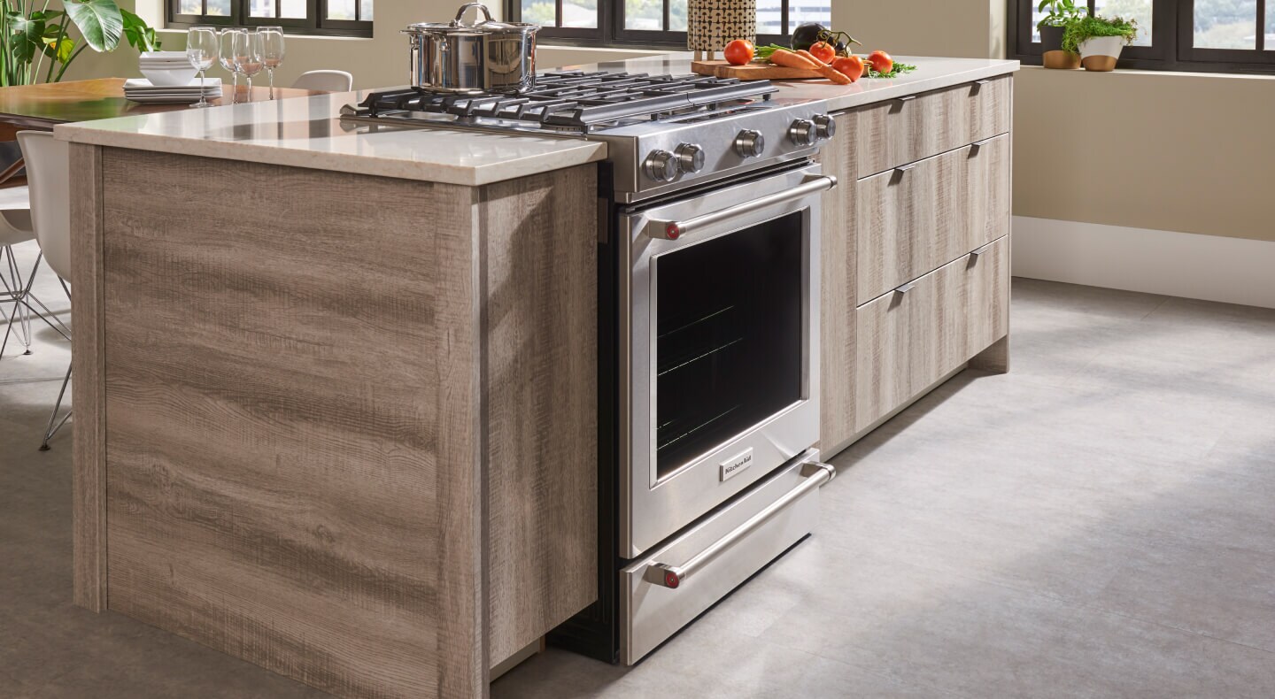 A KitchenAid® range set in a modern island