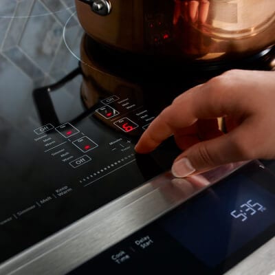 Person making selection on range control panel