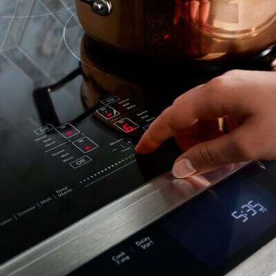 Person making selection on range control panel