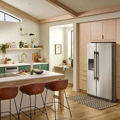 KitchenAid® large capacity refrigerator in brown cabinetry