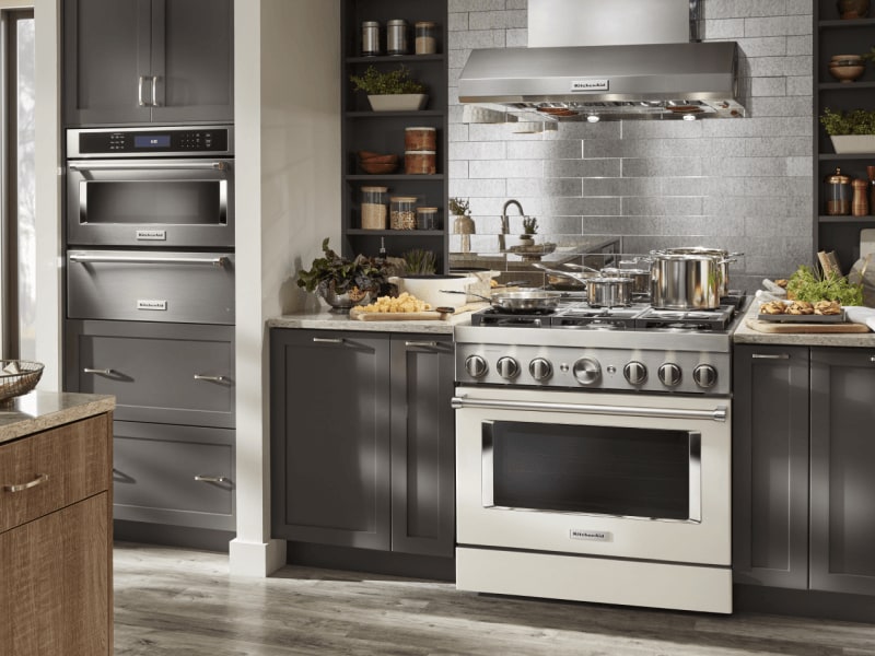 Kitchen with dark gray cabinets and stainless commercial-style range