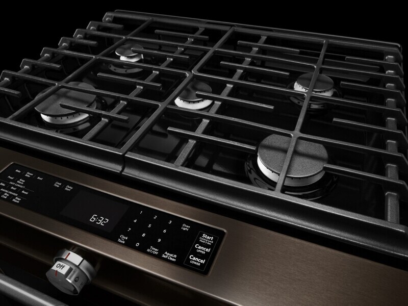 A gas stovetop with the burners shut off