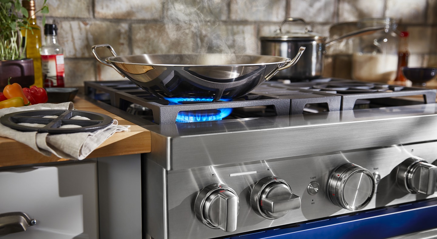 Wok heating on a KitchenAid® gas cooktop Wok heating on a KitchenAid® gas cooktop