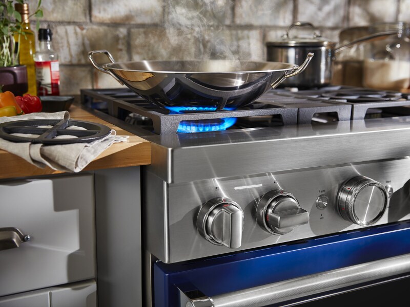 Wok heating on a KitchenAid® gas cooktop Wok heating on a KitchenAid® gas cooktop