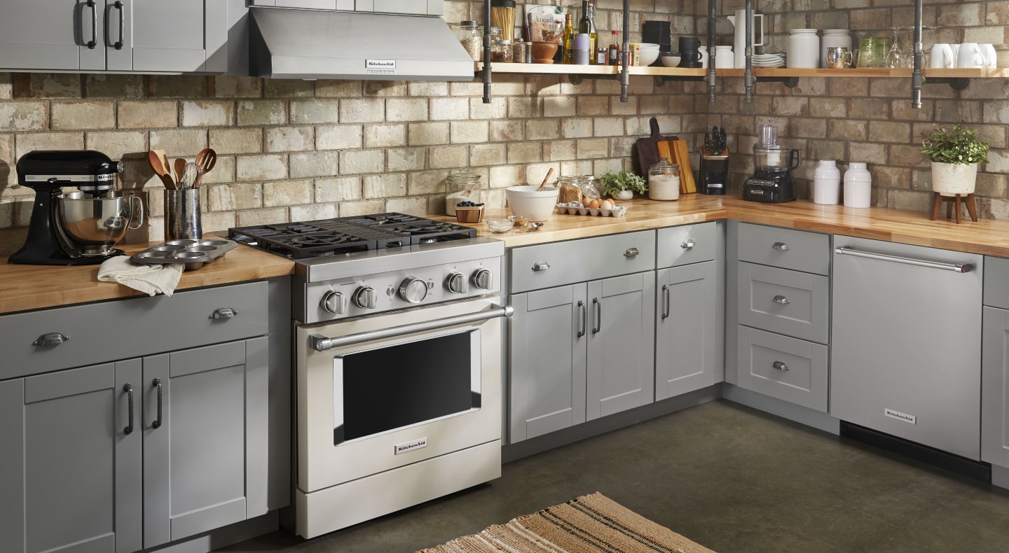 Stainless steel KitchenAid® gas range in a rustic kitchen Stainless steel KitchenAid® gas range in a rustic kitchen