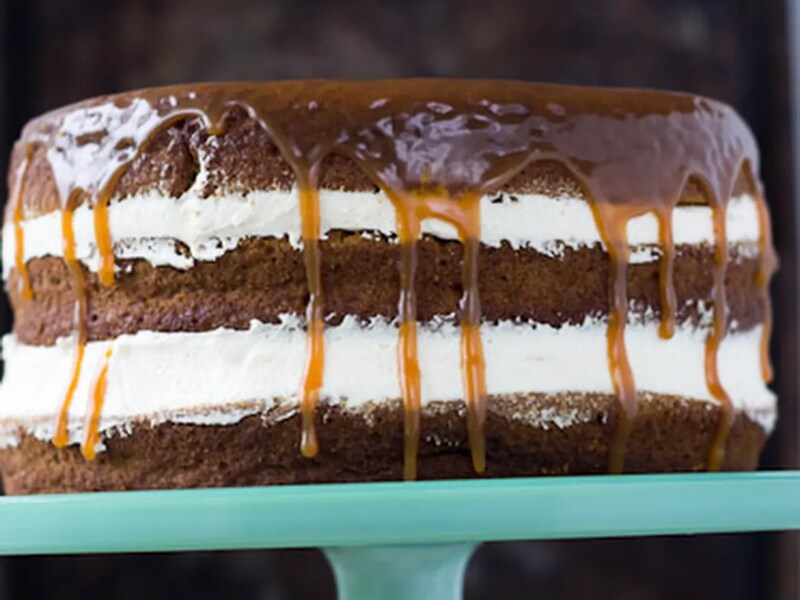 Naked pumpkin cake with caramel buttercream on blue cake stand