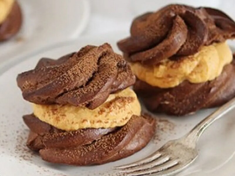 Pumpkin chocolate cream puffs next to fork