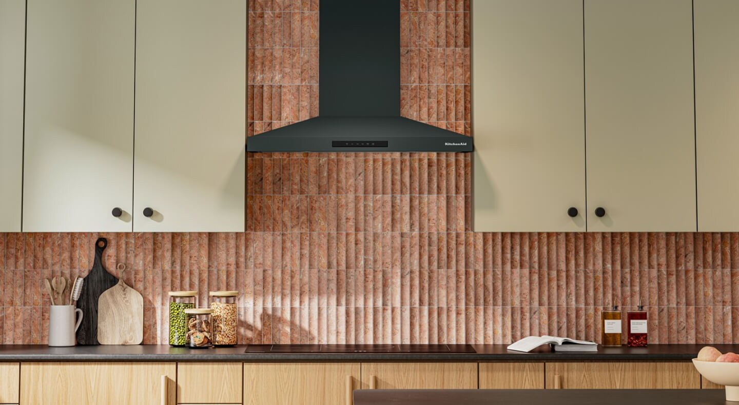 Juniper KitchenAid® range hood above an induction cooktop