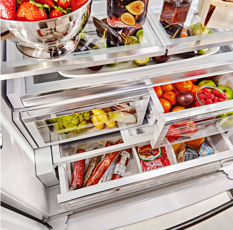 Stocked refrigerator with fruits and vegetables stored in crisper drawers Stocked refrigerator with fruits and vegetables stored in crisper drawers