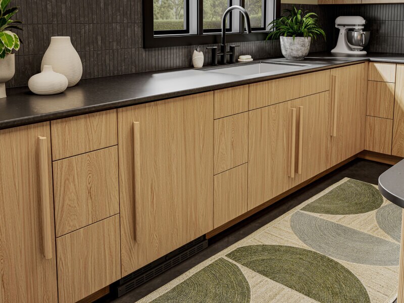 A Whirlpool® Panel-Ready Undercounter Refrigerator in a kitchen with light cabinets.