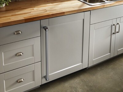 Beige cabinets with butcher block countertop