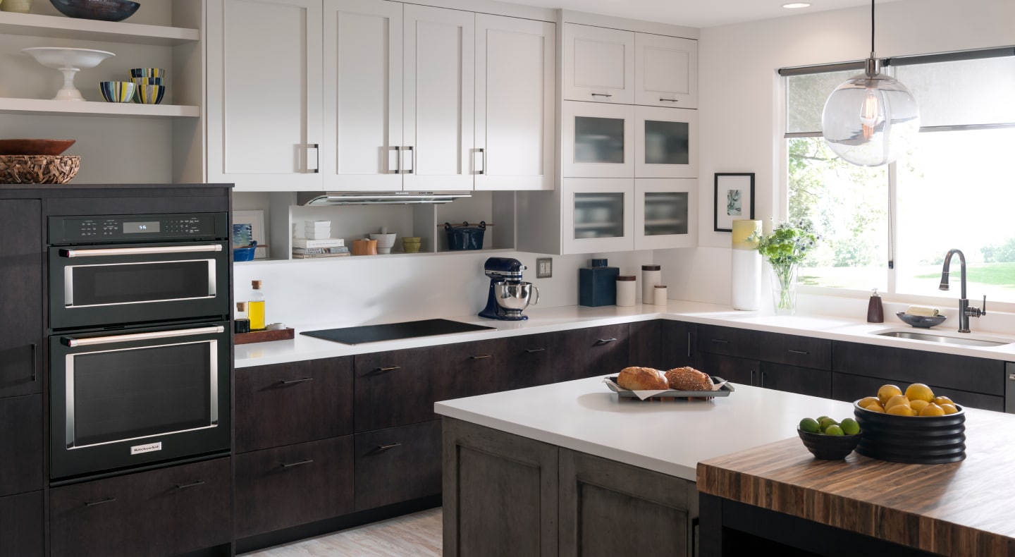 Black stainless steel KitchenAid® wall ovens in a black and white kitchen Black stainless steel KitchenAid® wall ovens in a black and white kitchen