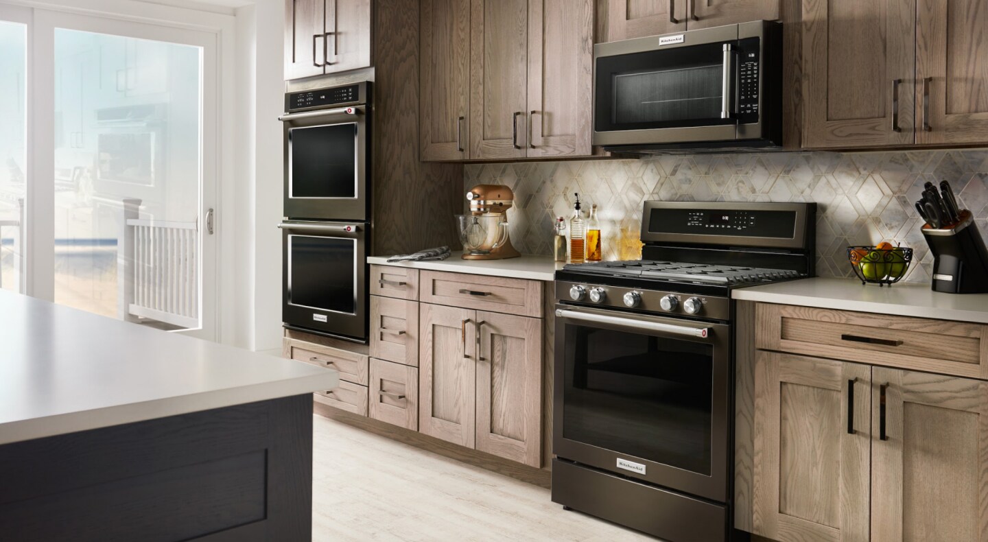 Black stainless steel KitchenAid® appliances in a rustic kitchen Black stainless steel KitchenAid® appliances in a rustic kitchen
