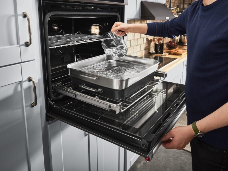 Person adding water to a pan