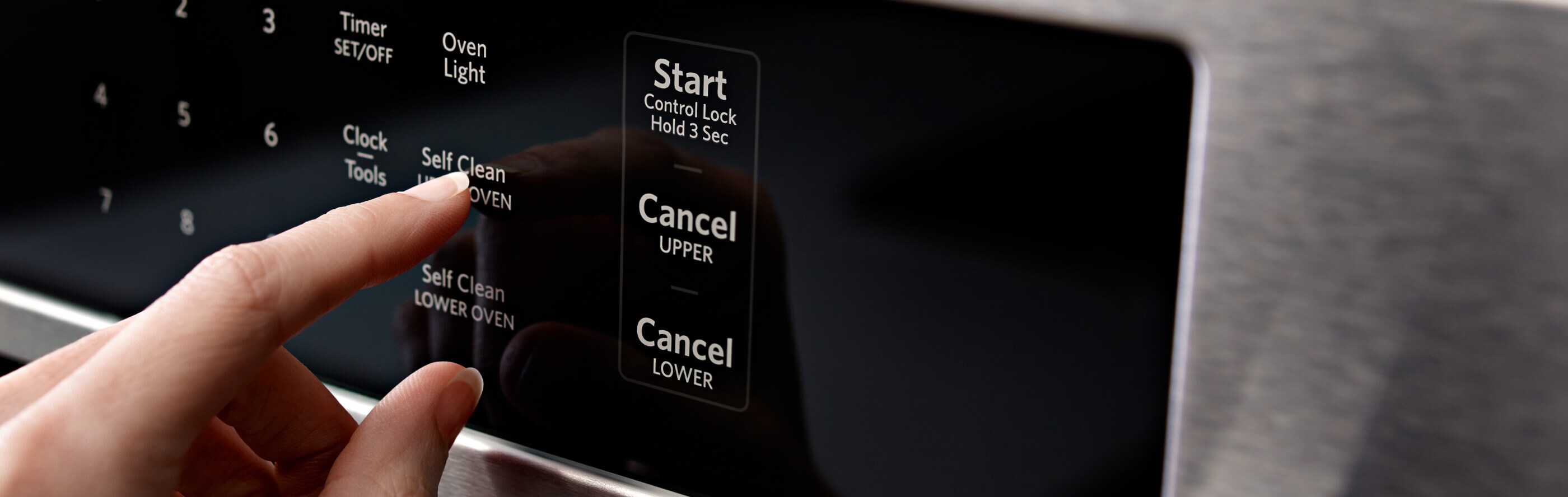 Person selecting cleaning cycle on oven