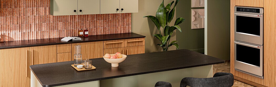 A modern kitchen with an island and double wall oven