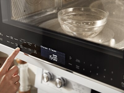 Person warming water in a microwave