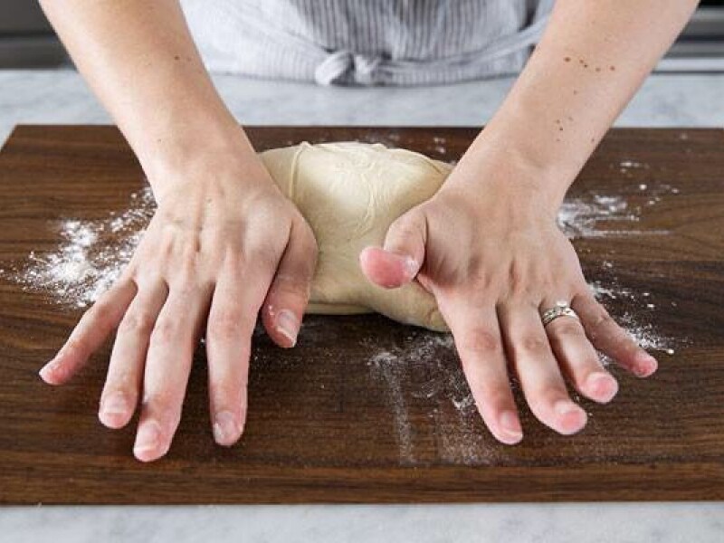 A person kneading bread by hand A person kneading bread by hand