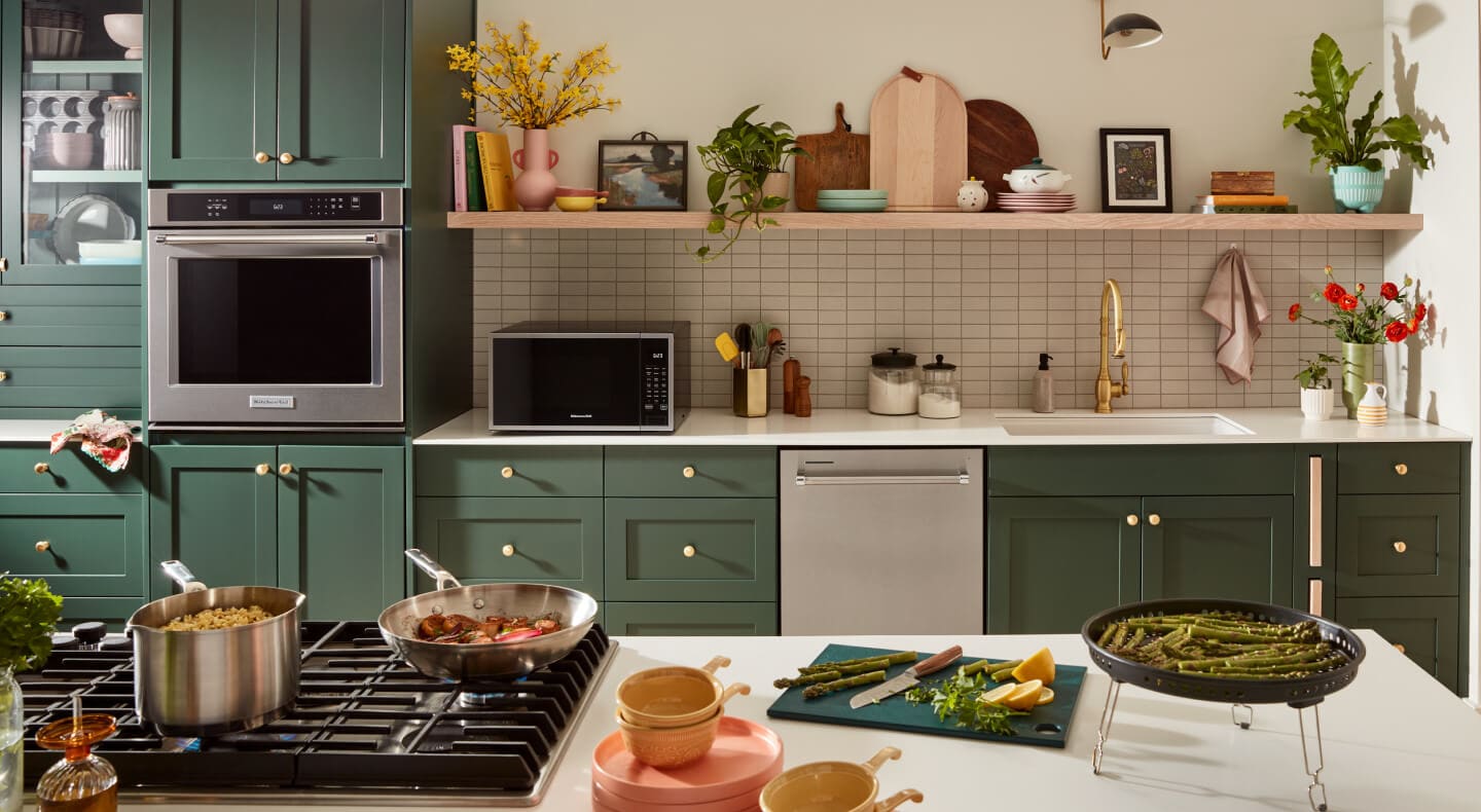 KitchenAid® appliances built into green cabinetry
