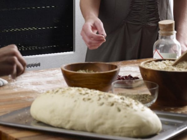 Person adding seasonings to dough