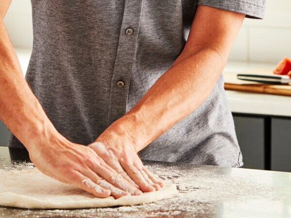 Person stretching dough