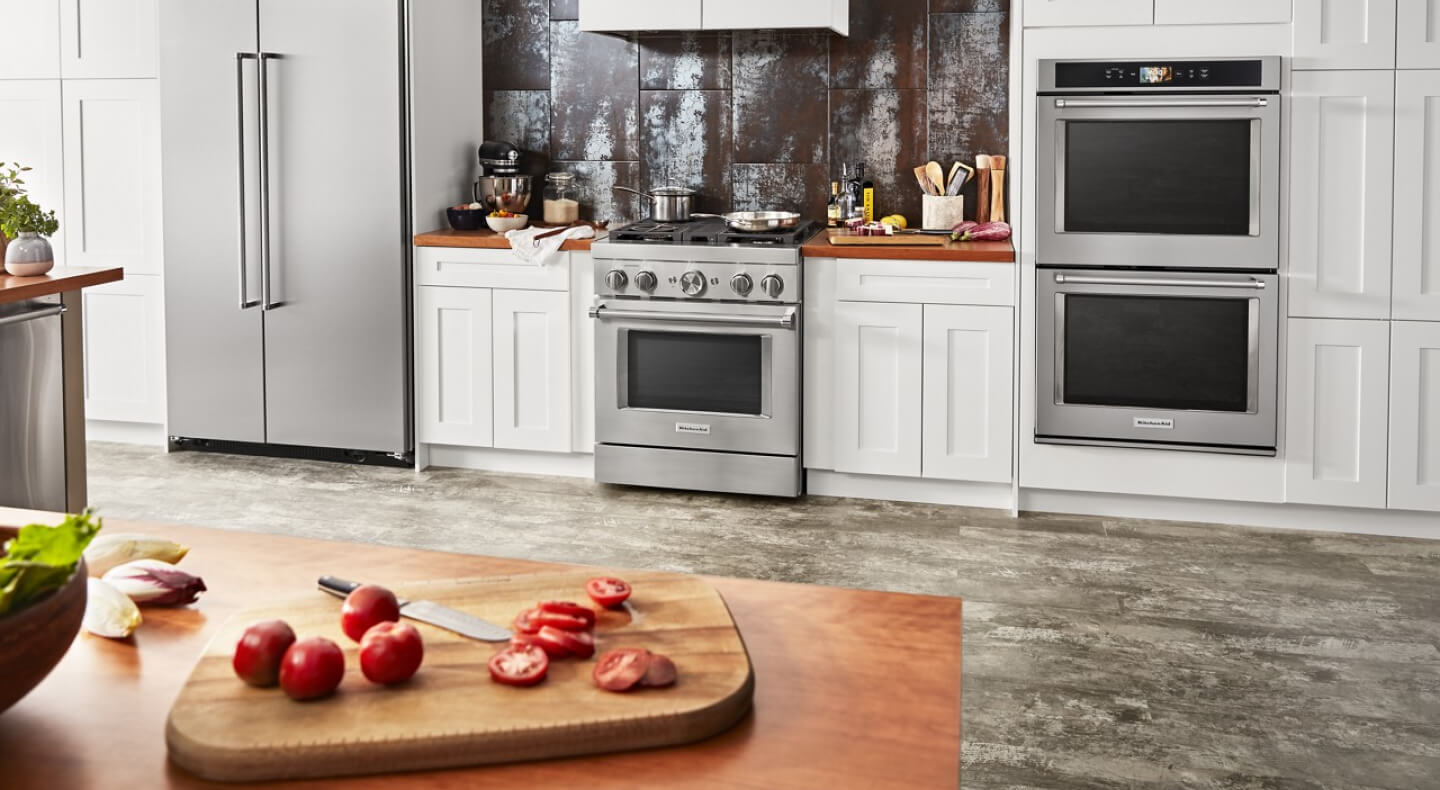 Stainless steel KitchenAid® appliances in an open concept kitchen