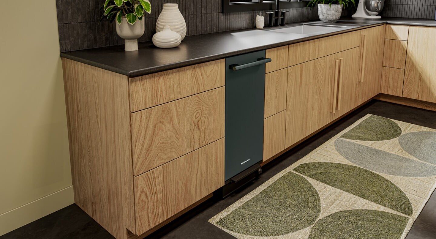Green trash compactor in a modern kitchen